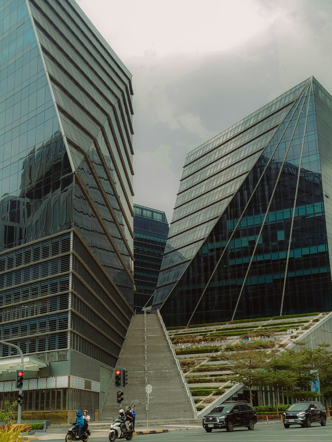 Diverse Malaysian team having a discussion outside a modern office building