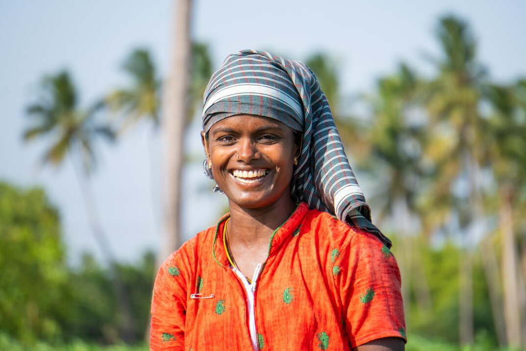 Malay woman in her twenties wearing a headscarf, editorial coordinator, smiling